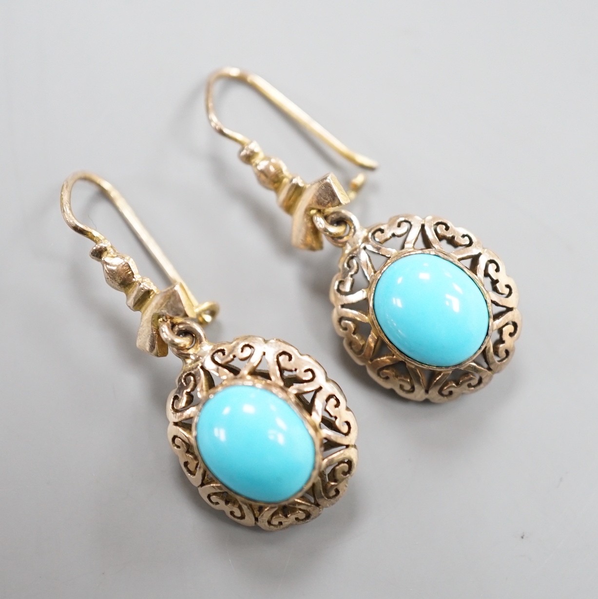 A pair of early 20th century pierced yellow metal and turquoise set drop earrings, 35mm, gross weight 4.3 grams.